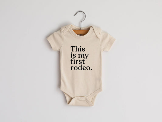 "this is my first rodeo" Cream Organic Baby Bodysuit