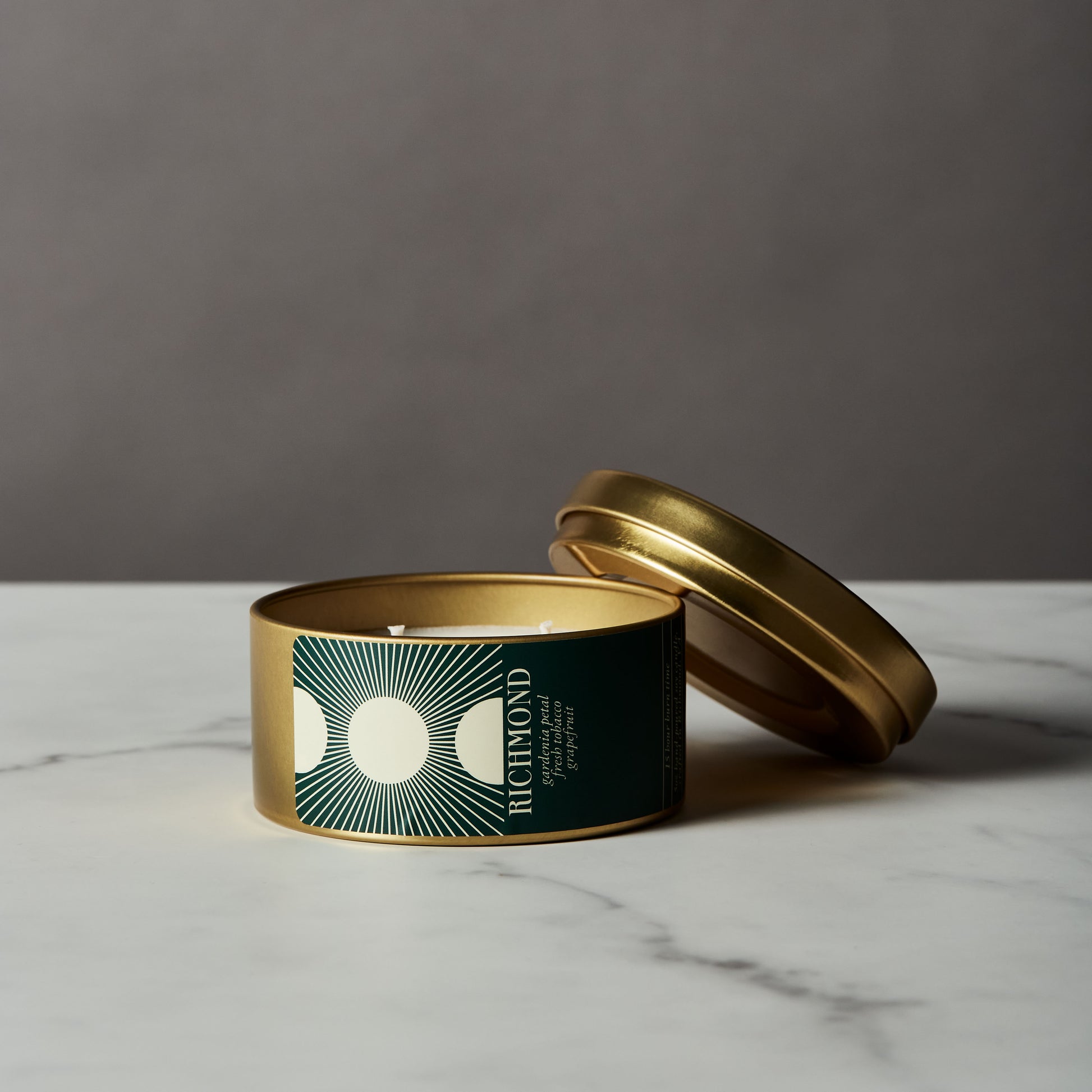 travel candle in modern gold tin with lid