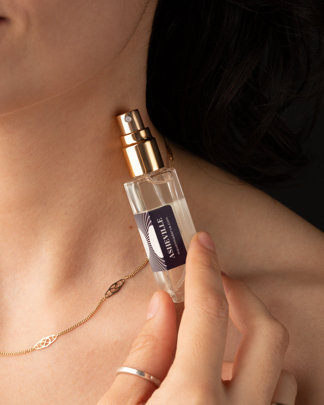 small perfume bottle against skin