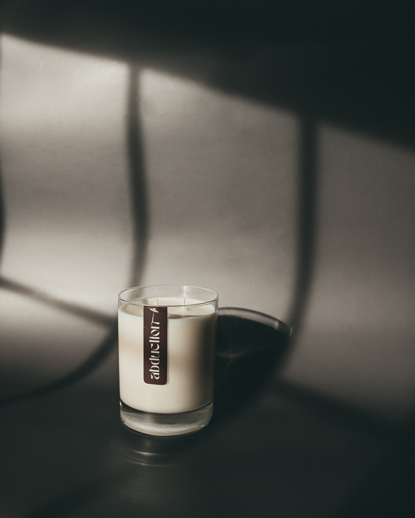 Candle  by Maven Theory Richmond VA with a label in a dark setting